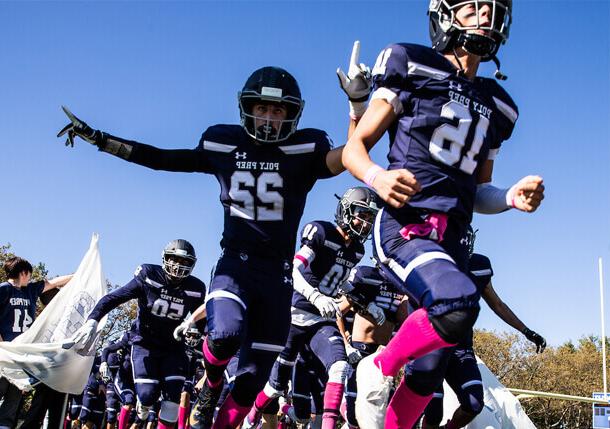 Poly Prep Homecoming Football players running to the field